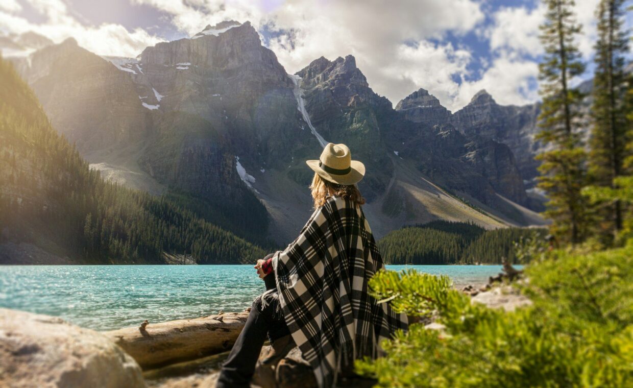 woman sitting near body of wate