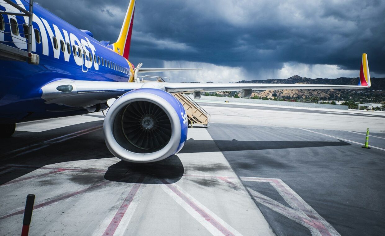 passenger plane on airport under gray cloudy sky