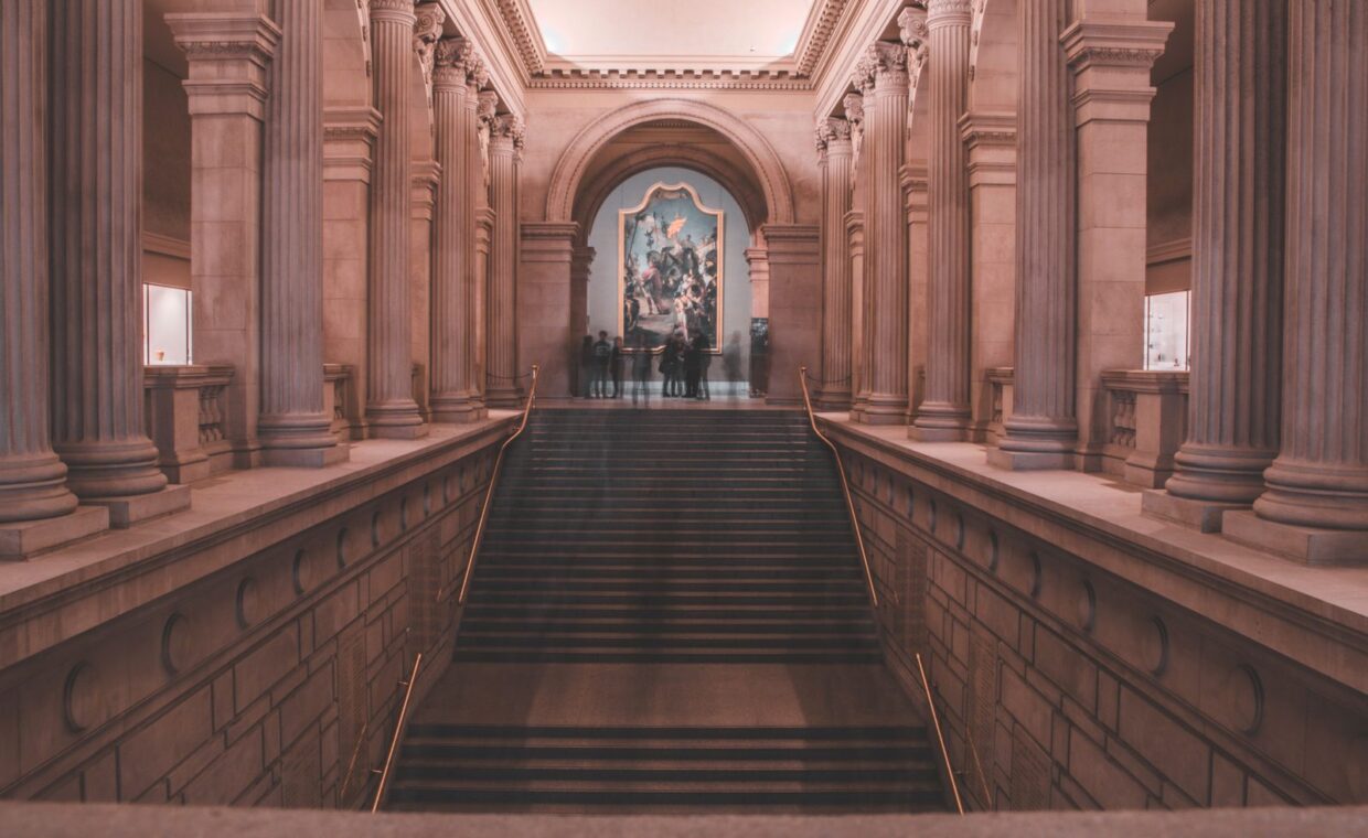 A grand staircase with elegant columns inside a renowned art museum in New York City.