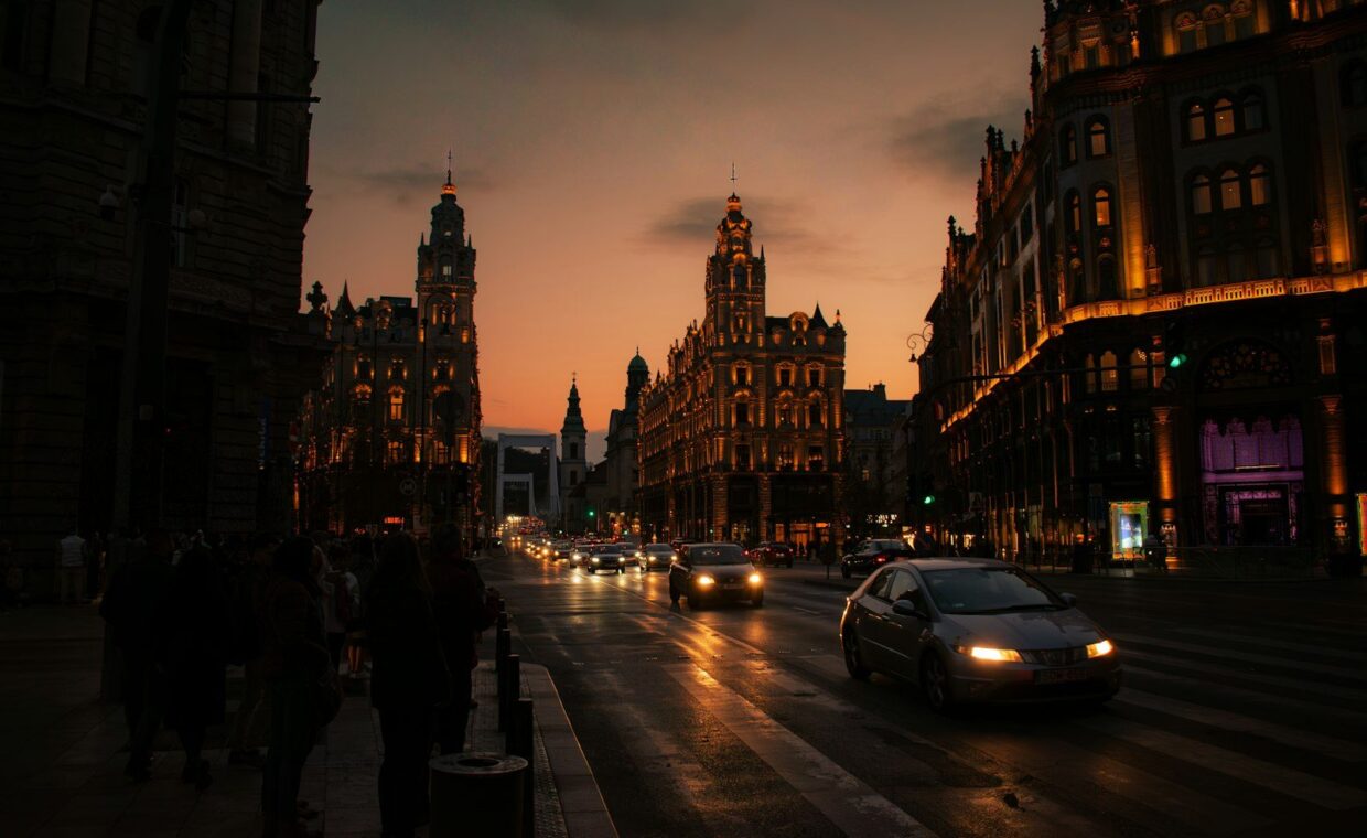 City street with cars and buildings at dusk