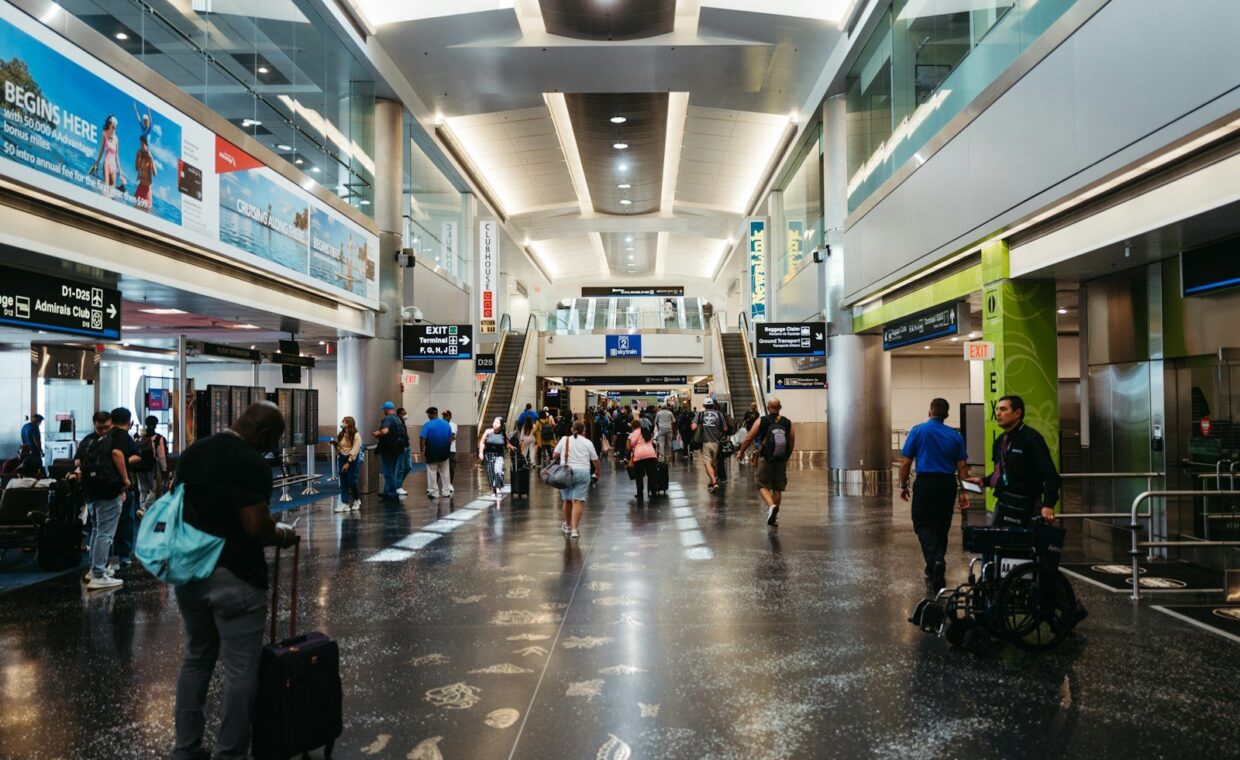 a group of people walking through an airport