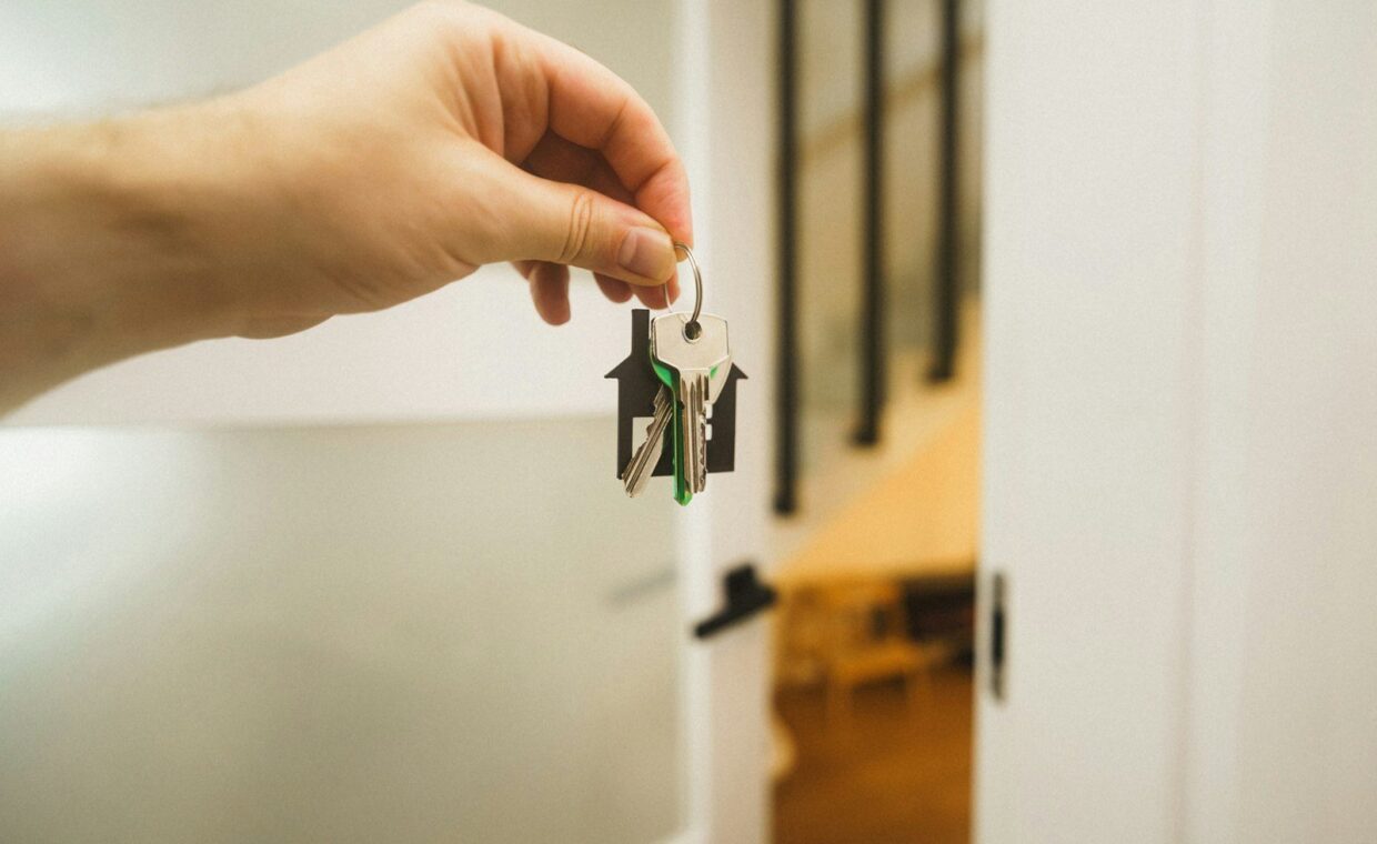 A hand holding a key to a door
