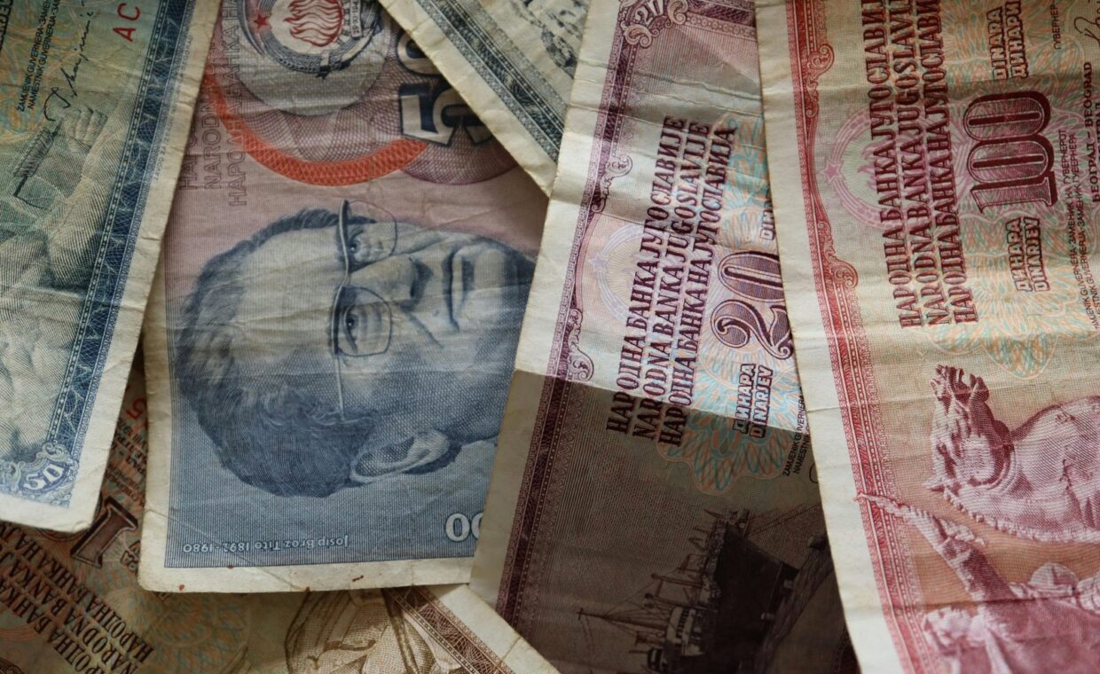 A close-up photo of diverse vintage banknotes, showcasing historical currency from different countries.