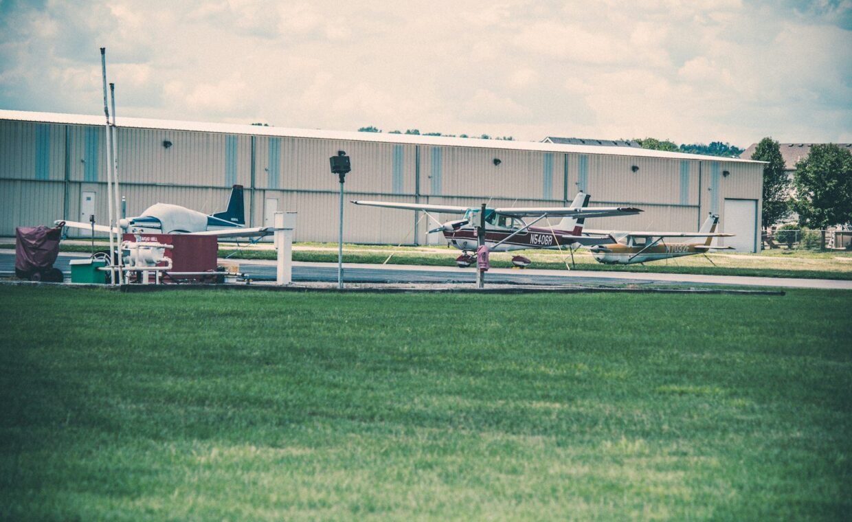 a small plane parked in front of a hangar