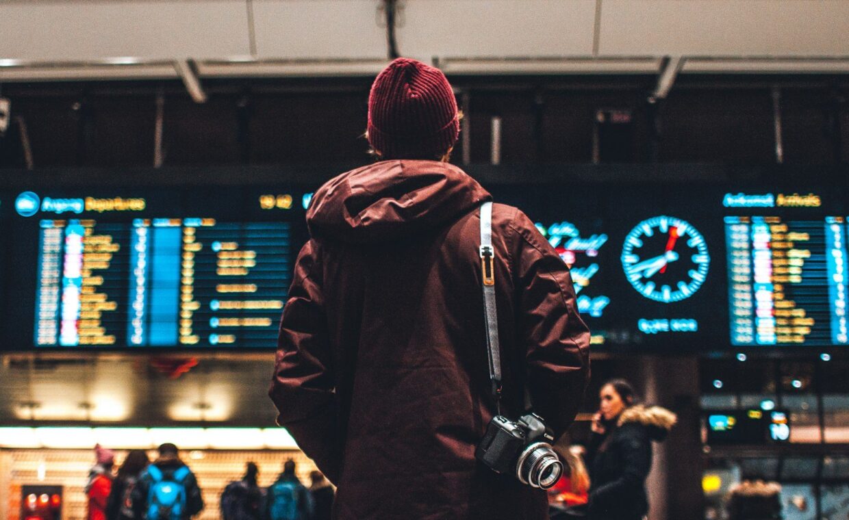 person looking up to the flight schedules