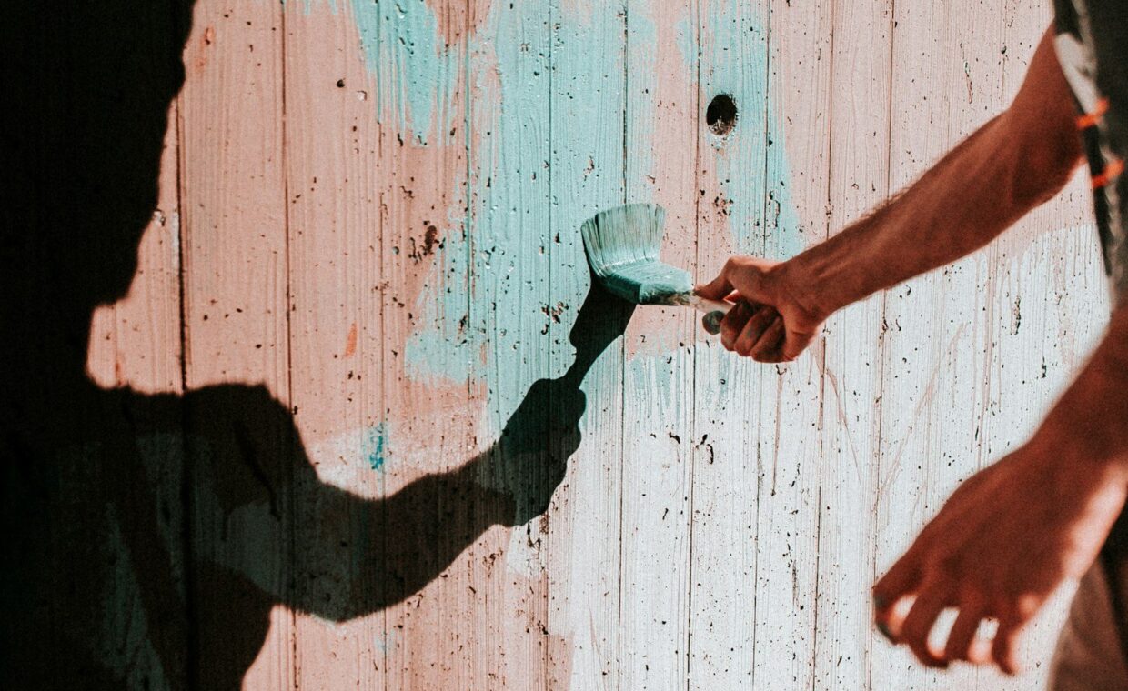 person painting wall